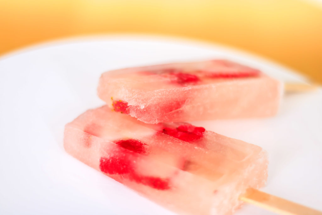 The delicate blush pink of the rosé punctuated by the bright red of the berries makes these Rosé Popsicles absolutely beautiful